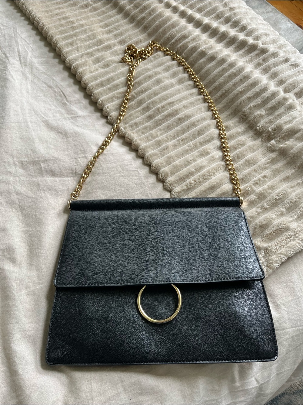 Black Leather Shoulder Bag with Gold Chain and Ring Accent